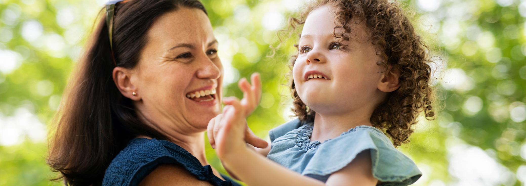 Cammy, living with TSC, being held by her mother.
